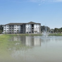 the exterior of a building near a pond